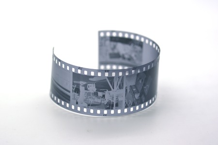 Strip of black and white film frames on a neutral backgroundの写真素材