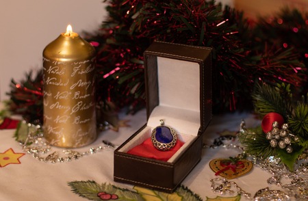 Gift box with a blue lapis lazuli stone in it with Christmas decoration