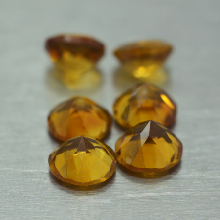 Group of ocher colored gemstones on metal surfaceの写真素材