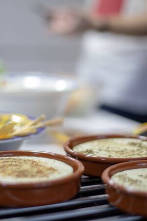 Clay plates with provolone cheese with herbs for gratinの写真素材