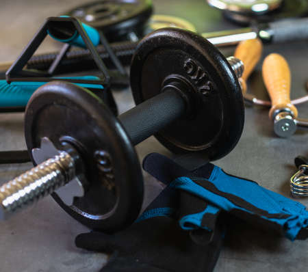 Items for training at the gym or at home. Dumbbells, Push up bars, weight plates of different sizes, jump rope, training gloves and hand grips.の写真素材