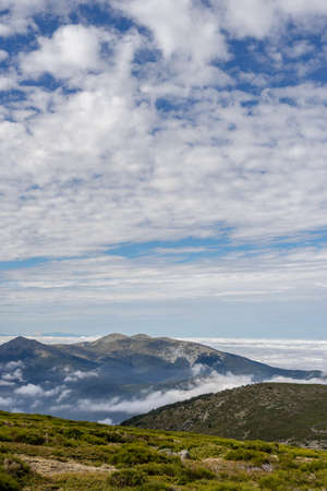 Beautiful sea of clouds from a mountain on a sunny day. Low clouds in the Sierra de Guadarrama, Madrid.の写真素材