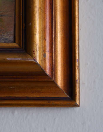Corner of a brown and gold old frame