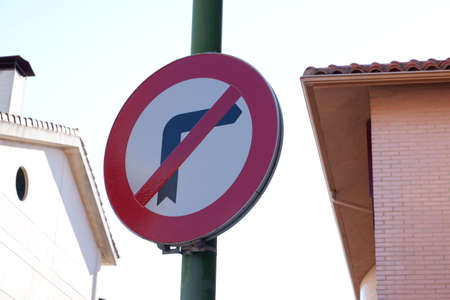 Transportation signal in a post with a house behindの写真素材