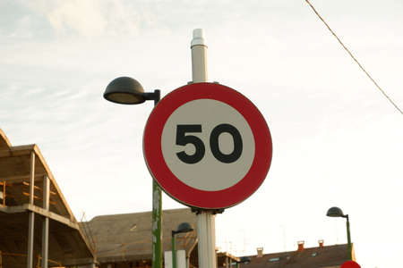 Transportation signal in a post with a house in construction behindの写真素材