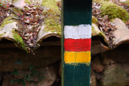 White, red and yellow post signal in a trekking pathの写真素材