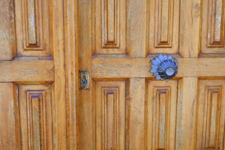 An old closed brown door in a villageの写真素材