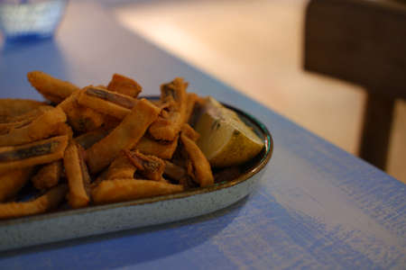 Fried squid in a plate with lemonの写真素材