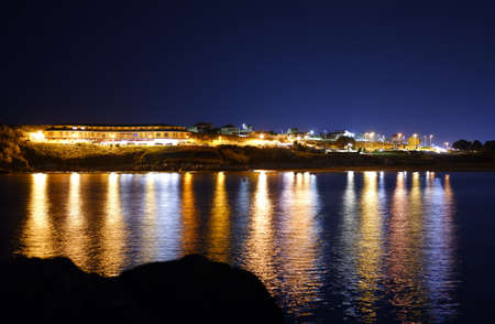 Streetlight reflex on the water during the night timeの写真素材