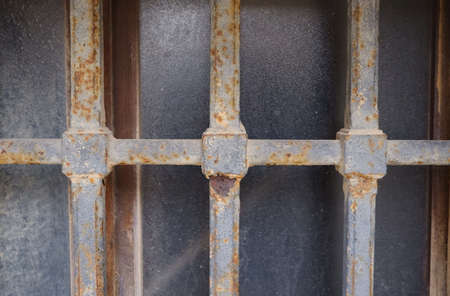 Rust metal bar in an old window