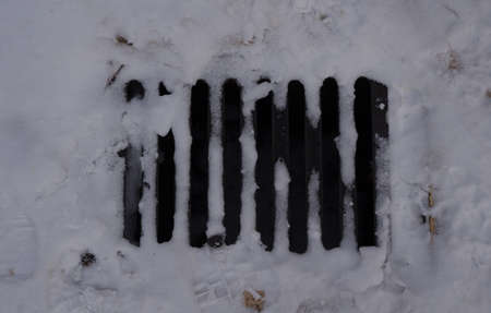 Snowed sewer close up after the stormの写真素材