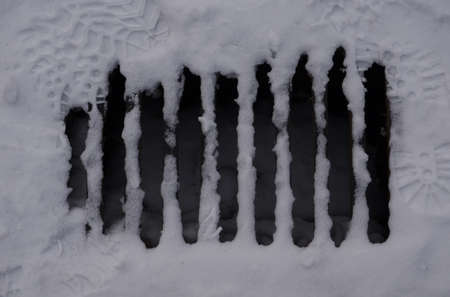 Snowed sewer close up after the stormの写真素材