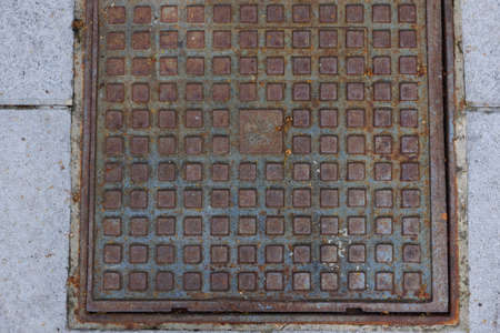 Old and rusty manhole in the streetの写真素材