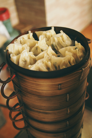 steamed fresh pork dumplings in bamboo basket, dim sumの写真素材