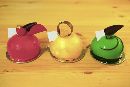 three varieties of mirror glaze mini mousse cakeの写真素材