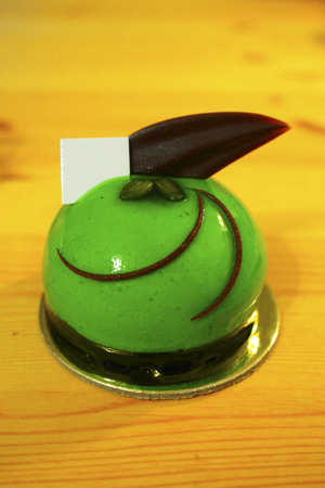 green colour mirror glaze mini mousse cake with chocolate toppingの写真素材