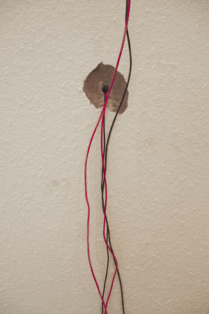 Exposed electrical wires in the wallの写真素材