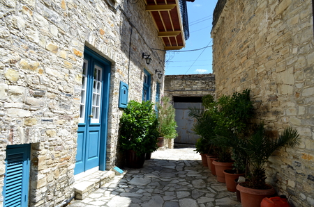 Narrow Greek Cyprus Street - White houses with blue doorの写真素材