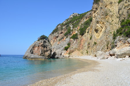 Beautiful Secret Virgin Beach Surrounded by Rocky Cliffs. Corfu Island, Greeceの写真素材