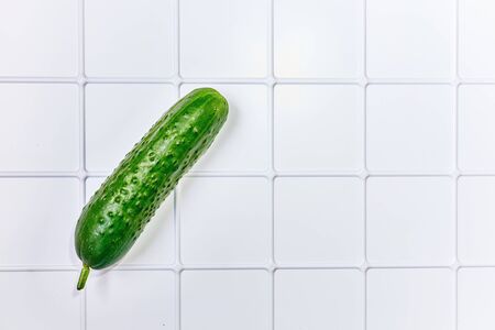 Green cucumber on a white back groundの写真素材