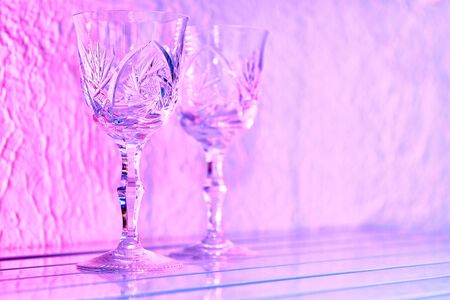 Two crystal glasses on a pink backgroundの写真素材