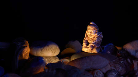 Buddhist monk warming himself by the fire at night