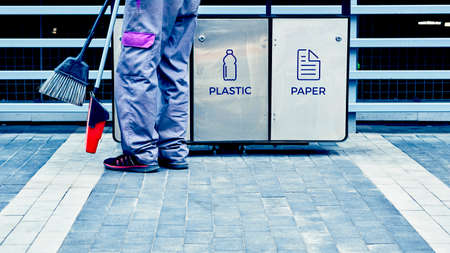 Waste containers and janitors feet, keep your planet Earth cleanの写真素材