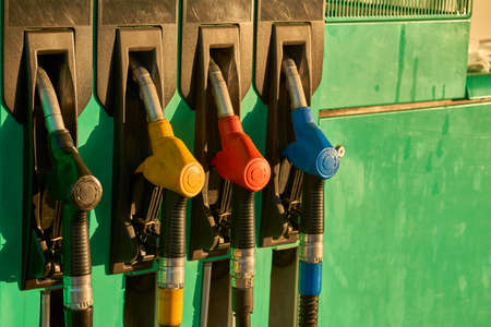 A refueling gun wakes up a gray car at a gas station