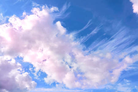 Saturated blue sky with flying pink clouds