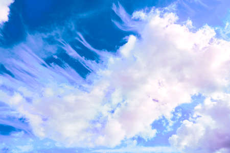 Saturated blue sky with flying pink clouds