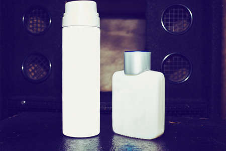 Two plastic bottles vial for oils, perfumes on a dark backgroundの写真素材