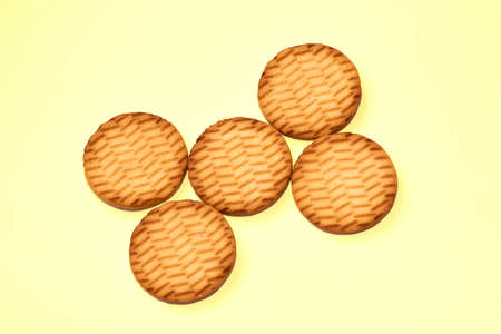 Sweet dessert cookies crekers triangle are a tasty product.Isolated on yellowの写真素材
