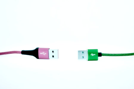 Keep distance.Two USB cable on the white background.の写真素材