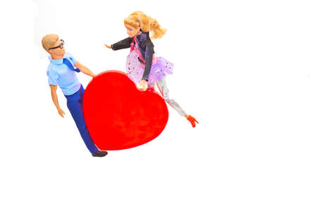 Lovely young toy couple and big love heartの写真素材