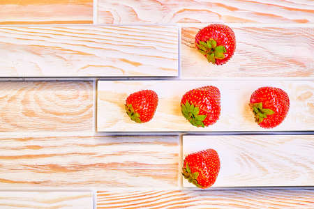 Fresh juicy strawberries full of vitamins on a wooden surfaceの写真素材