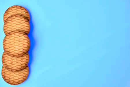 Five sweet dessert cookies crekers are a tasty product.Isolated on blue