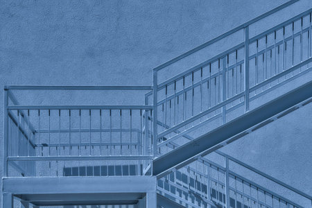Gray metallic staircase landing and wall in blue moonlightの写真素材