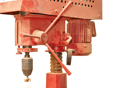 Red ginger professional drilling machine isolated on white background.
