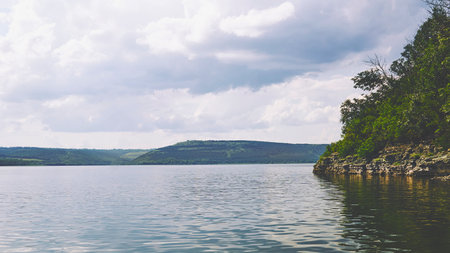 Summer river flowing among lush green rocky hills. Tovtry National Park Ukraineの写真素材