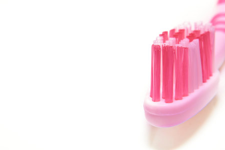 Pink toothbrush on white background close upの写真素材