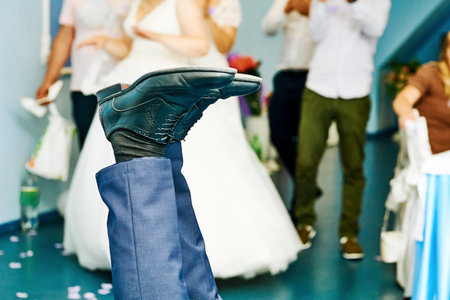 Legs of a man in shoes at a wedding competition, a gameの写真素材