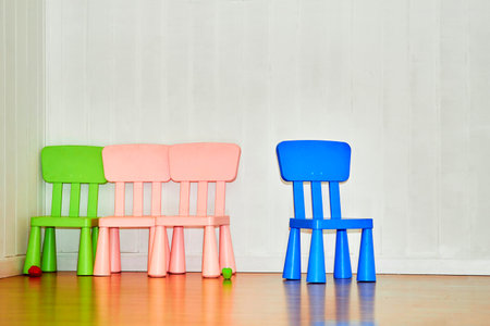 Multi colored children's chairs in the playroom in kindergartenの写真素材