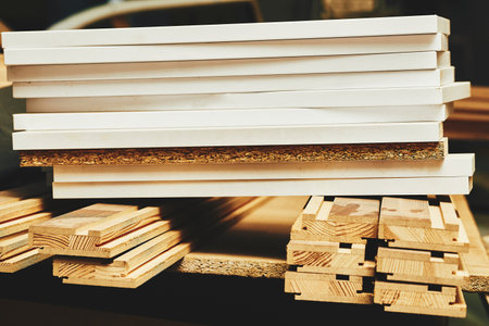 Sheets of plywood, boards, lumber stacked in rows in a carpentry in a warehouseの写真素材