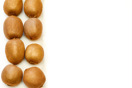 Several ripe tasty kiwis in row isolated on whiteの写真素材