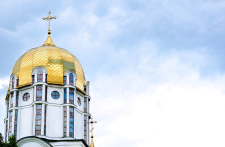 The golden domes of the church and the cloud blue sky on a warm Easter dayの写真素材