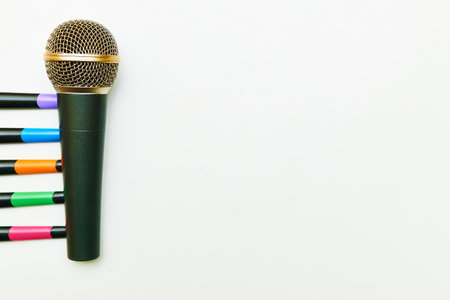 Vocal microphone for singing karaoke with colorful sticks isolated on whiteの写真素材