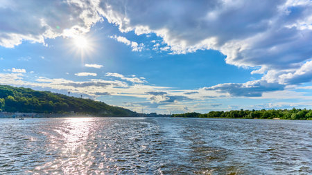 View from a motor boat to the wide sunny expansion of the Dnieper River, Kyiv