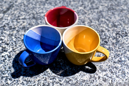 Time of ceremony for tea and coffee.Colorful cups on gray marble surfaceの写真素材