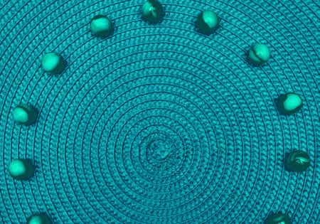 Green emerald spiral round straw background with green balls. Place for textの写真素材