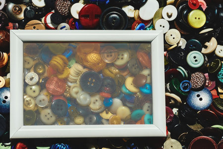 White blur frame on scattered different buttons of a tailor in a shopの写真素材